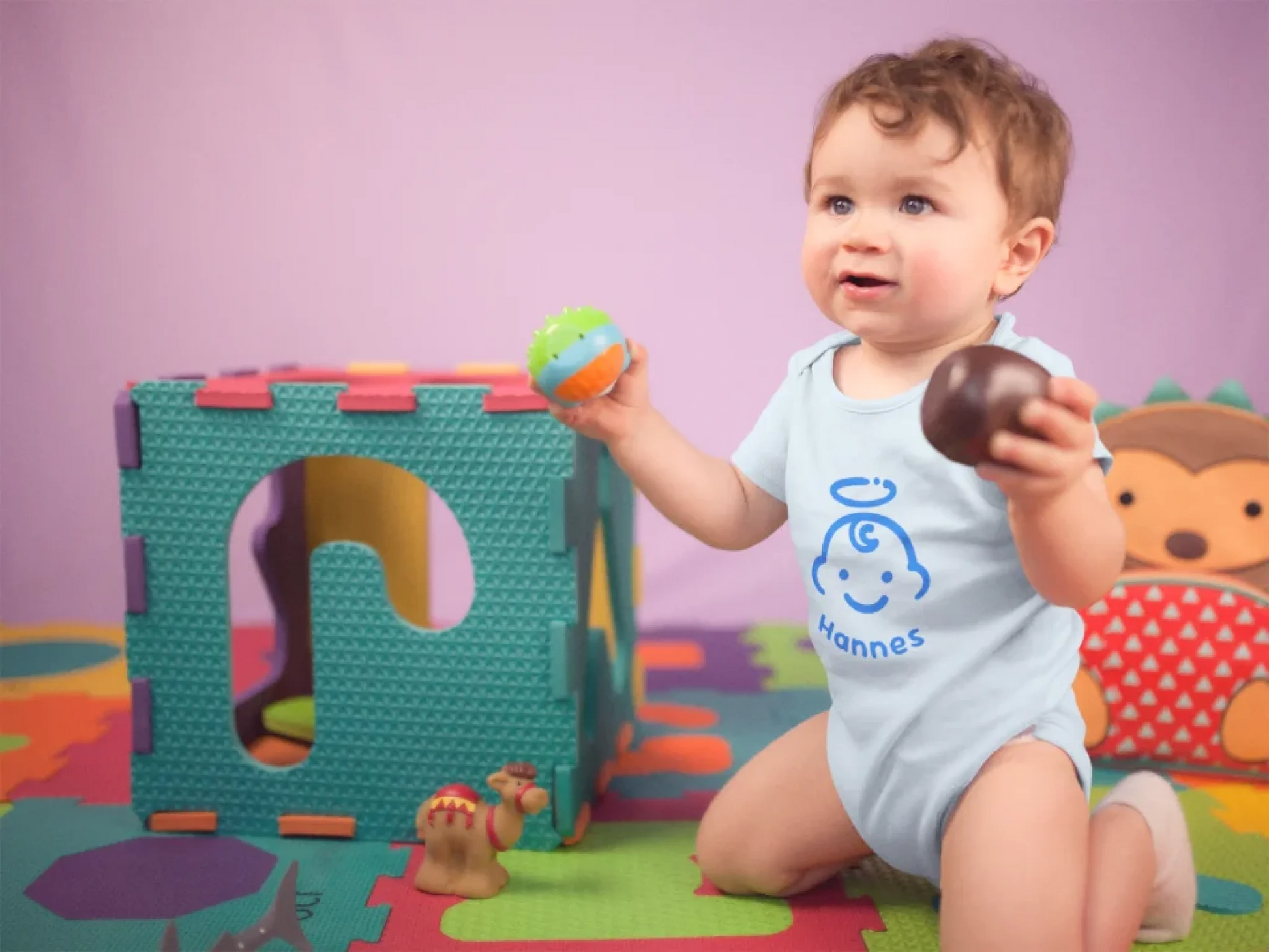 pretty-baby-boy-playing-with-toys-wearing-a-onesie-while-on-his-knees-at-his-playground-mockup-a14023