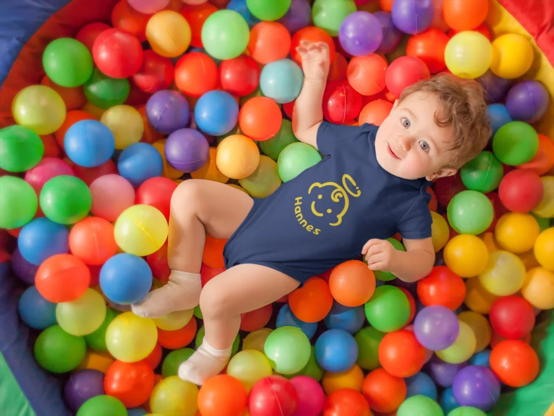 pretty-baby-boy-having-fun-at-a-ball-pit-wearing-a-onesie-mockup-14021