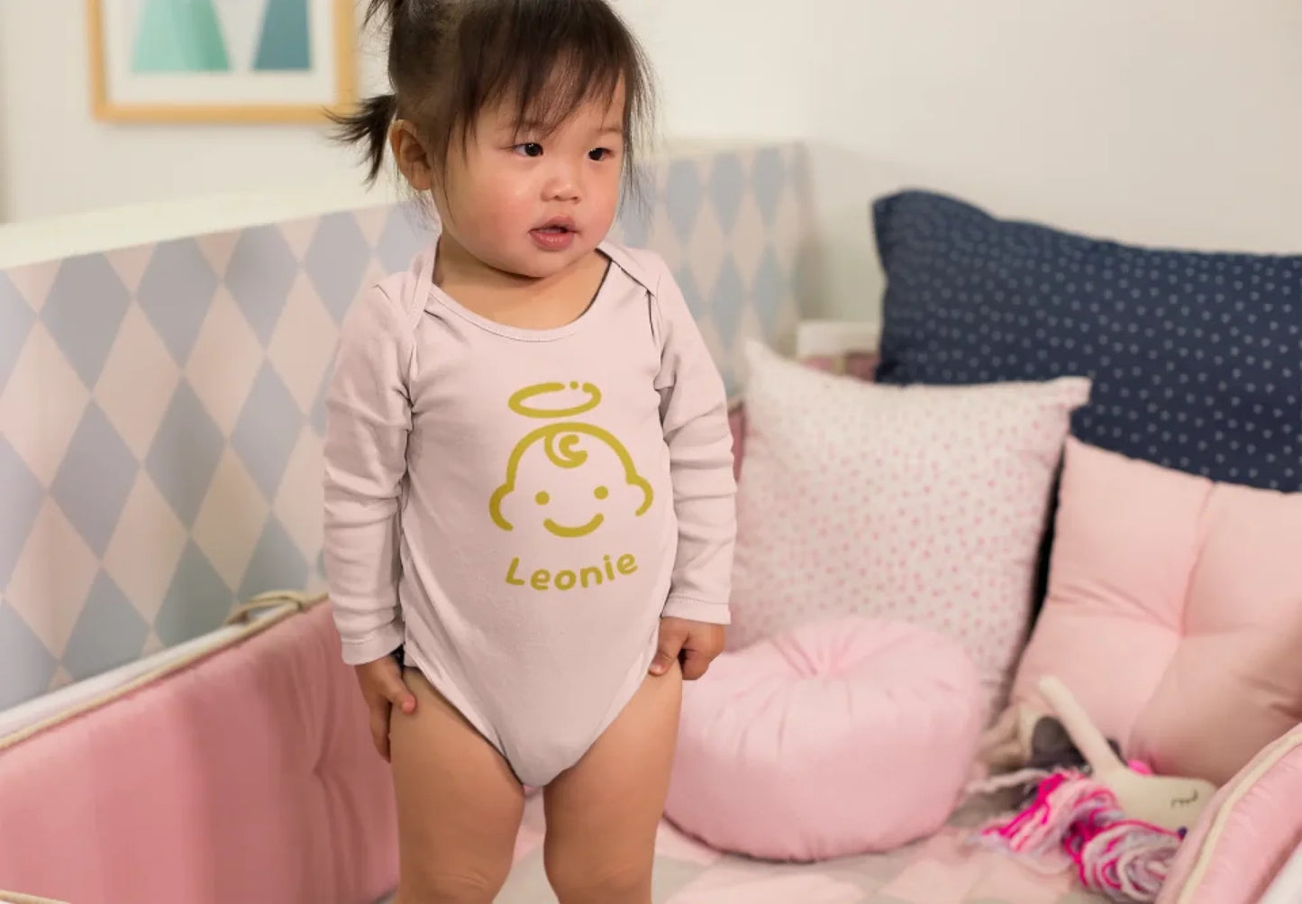 mockup-of-an-adorable-baby-girl-wearing-a-onesie-in-her-crib-25135